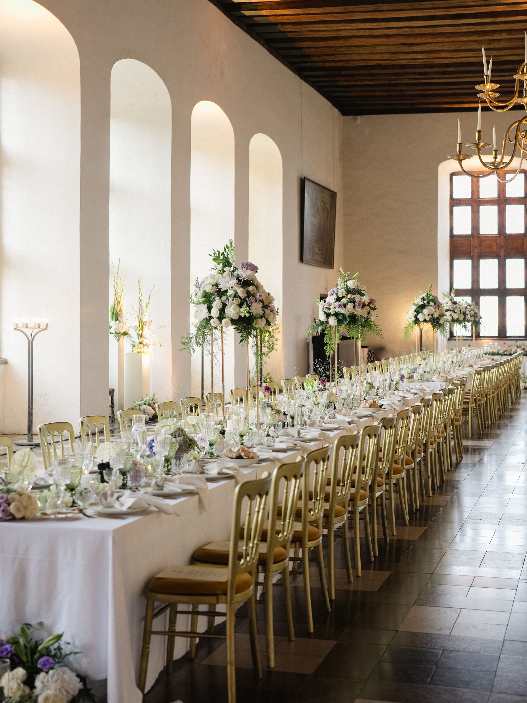 Grand banquet at Kronborg Castle with Renaissance paintings and luxury floral arrangements